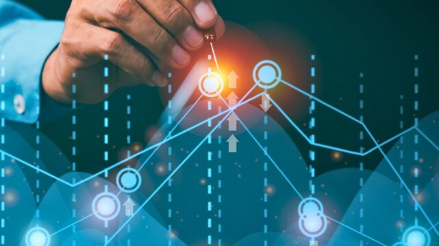 Hand interacting with glowing digital financial data graph
