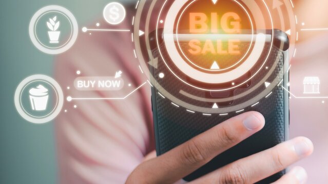 Person holding phone with big sale graphic and shopping icons
