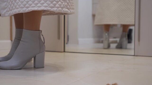 Confident Departure: Heeled Boots Clack Sharply on Tile Floor