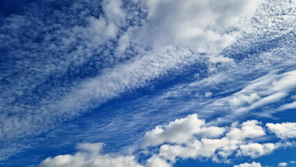 Different structure of white clouds on blue sky