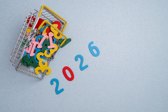 Planning goals for 2026: miniature shopping basket spilling out colorful letters and numbers on a pastel background.