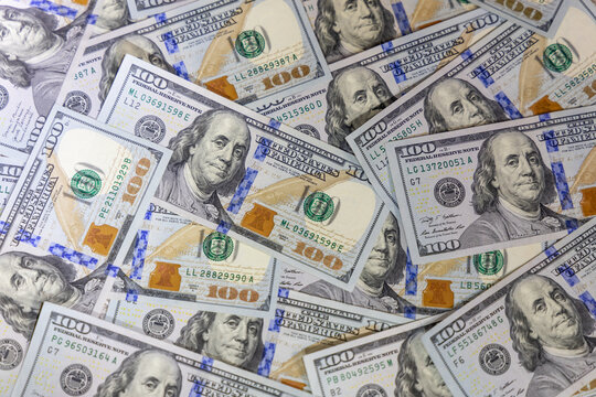 US dollar banknotes arranged on flat surface featuring detailed currency design, denominations and texture representing finance, economy, banking, investment, wealth and American monetary system