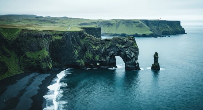Dramatic coastal landscape with a natural rock arch formation. Volcanic black sand beach and steep green cliffs. Epic travel destination in Iceland for tourism and adventure - Powered by Adobe