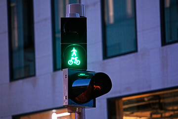 traffic light with a green man figurine permitting pedestrians to cross the road. Pedestrian and...