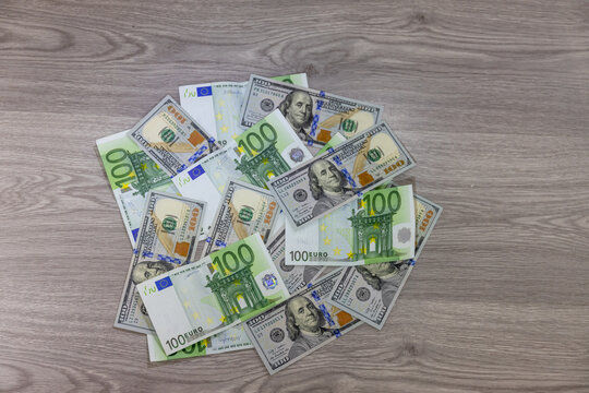 US dollar and Euro banknotes arranged on flat surface featuring currency details, denominations and textures representing finance, economy, global trade, investment, banking and international monetary - Powered by Adobe