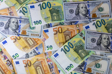 Obraz premium US dollar and Euro banknotes arranged on flat surface featuring currency details, denominations and textures representing finance, economy, global trade, investment, banking and international monetary