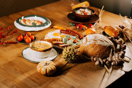 Delicious breakfast spread with fresh bread, eggs, and seasonal fruits on a wooden table - Powered by Adobe