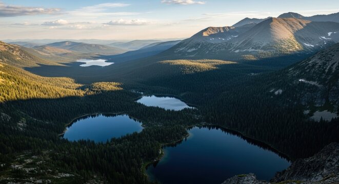 Scenic mountain range with pristine alpine lakes. Aerial perspective of a vast wilderness valley. Outdoor adventure and eco tourism destination. Golden hour light on a forest landscape - Powered by Adobe