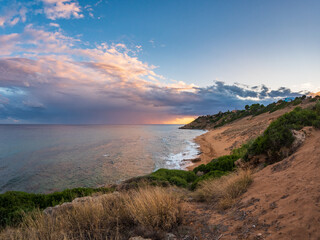 Golden sandy beach of Le Cannella Capo Rizzuto Calabria Italy with turquoise waters rocky shoreline and sunset sky symbolizing freedom nature serenity and Mediterranean summer allure.