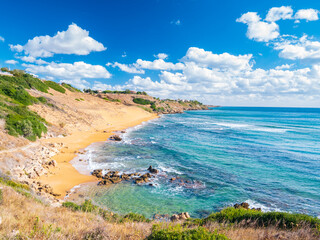 Golden sandy beach of Le Cannella Capo Rizzuto Calabria Italy with turquoise waters rocky shoreline and vivid sky symbolizing freedom nature serenity and Mediterranean summer allure.