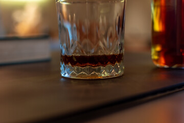 Close-up of a glass containing neat Bourbon on a dark surface. Focusing on the rich color, crystal glass texture, and elegant tasting moment. Ukraine, Zhytomyr, November 5, 2025