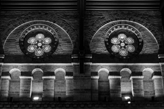 A building with historic architecture and circular windows.  - Powered by Adobe