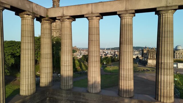 Exploring calton hill national monument of scotland in Edinburgh with a view of the city during the evening