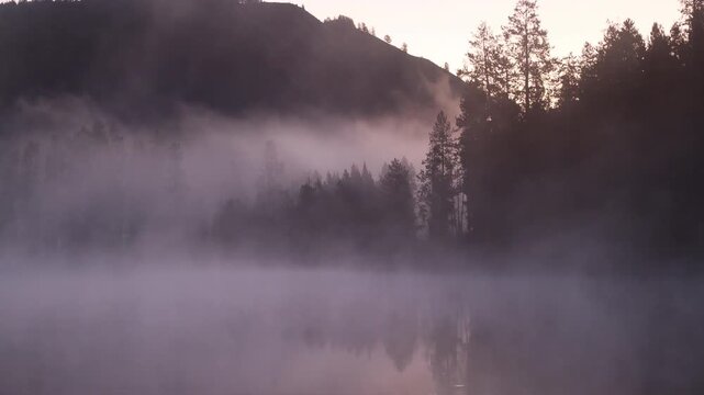 Fog Lifting at Dawnon the Snake River  in Autumn in Grand Teton National Park Wyoming