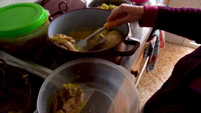 Slow motion. The grandmother cook puts the food in a plastic container