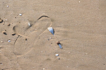 Fork buried in sand
