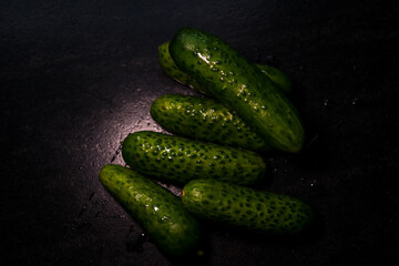 A few cucumbers and greens in close-up