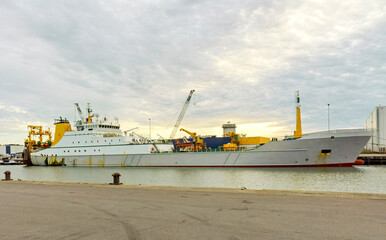 stern trawler is moored at the harbour quay ready to be unloaded