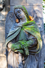 Naklejka premium Historic Statue on the autumn mystery old Prague Cemetery, Czech Republic