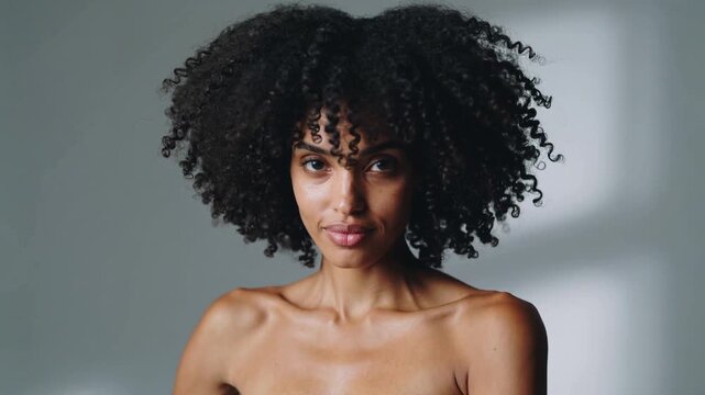 Confident model with afro hairstyle and shiny curls