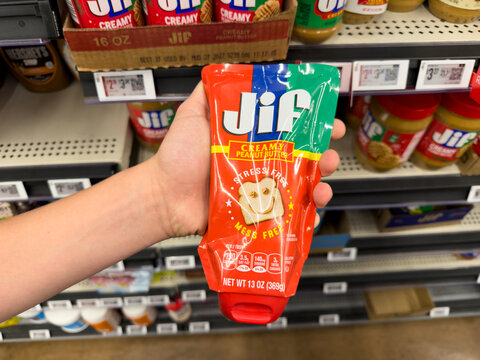 Jif Peanut Butter Squeeze Pouch Held In Grocery Store Aisle