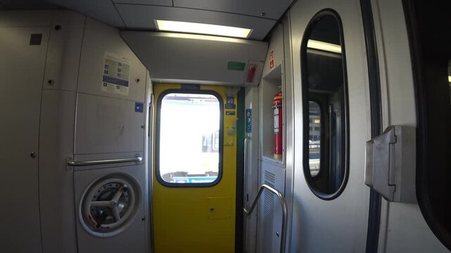 The vestibule of a Swiss passenger train. Passing Rotkreuz station, Switzerland.