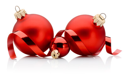 Three red Christmas baubles and curling paper ribbon isolated on white background