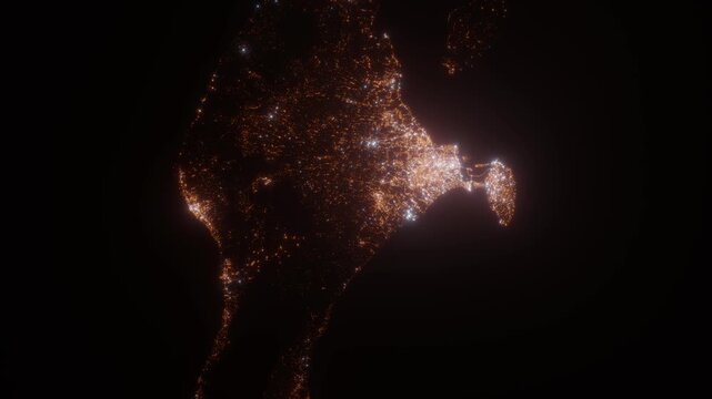 Bali (Indonesia) top view at night. Top view on modern city with street lights and glow effect. Camera is zooming in, rotating clockwise. Vertical video. The north is on the left side