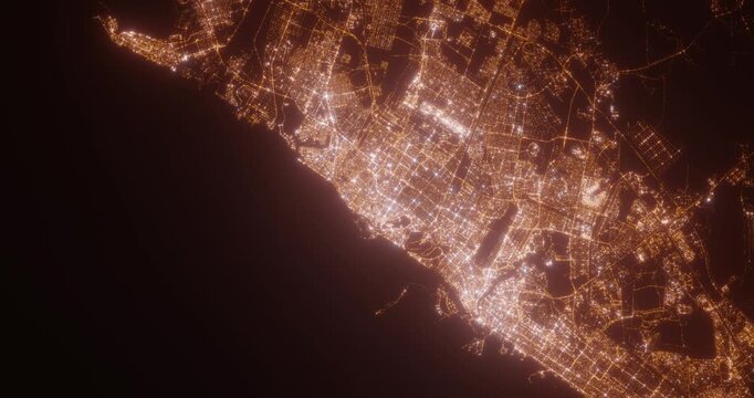 Sharjah (UAE) top view at night. Aerial view on modern city with lights. Camera is flying above the city, moving backward. Vertical video. The north is on the left side