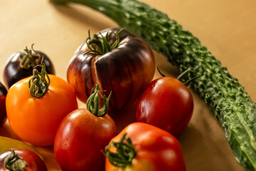 diverse collection of organically grown heirloom vegetables and fruits displayed outdoors with warm