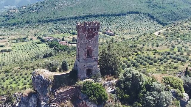 Caprona, Tuscany. Aerial view of famous medieval tower on the mountain top. Slow motion