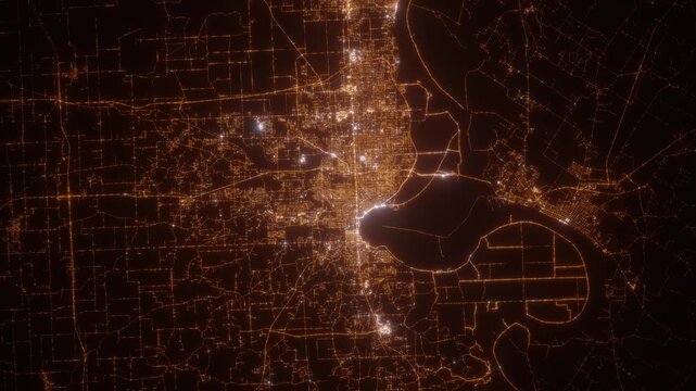 Evansville (Indiana, USA) top view at night. View on modern city from satellite. Camera is zooming in, rotating counterclockwise. Vertical video. The north is on the left side