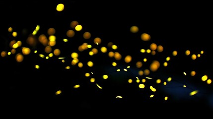 Mesmerizing Display of Glowing Yellow Particles Dancing Against a Dark Background, Capturing the Essence of Light and Motion