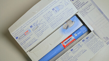 Fototapeta premium Ozempic Injection box package and pen closeup display with instructions. Ozempic drug medication for Diabetes treatment. Unprescribed abuse for weight loss: Toronto, Ontario, Canada - October 28, 2025
