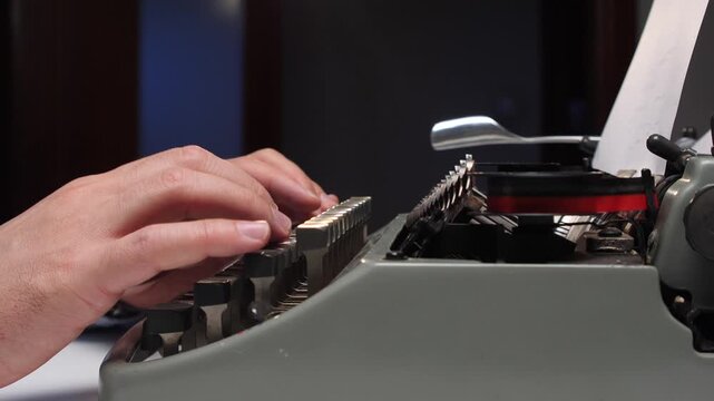 Hands typing on an old manual typewriter, close up of fingers striking keys as text appears on papervintage writing scene evoking nostalgia, creativity, and focused work