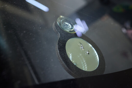 Detailed evaluation of resin patch and reflective surface integrity, Thorough inspection through natural lighting to ensure repair quality and visual perfection