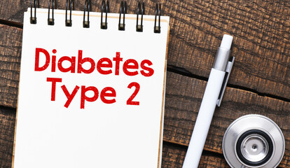 DIABETES TYPE 2 words in the notebook next to the stethoscope.