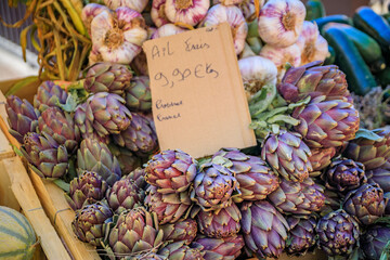 Purple artichokes at a vegetable stand at the farmers market in Nice, France