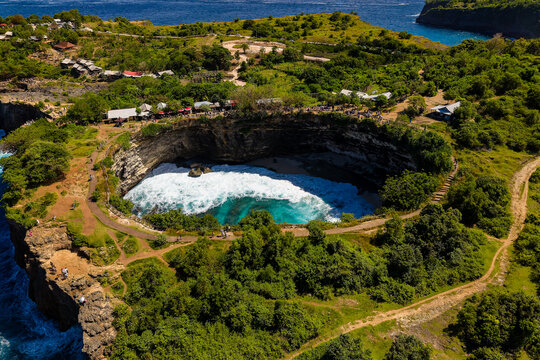 High angle view of a unique circular cove and natural bridge on a tropical island cliff - Powered by Adobe