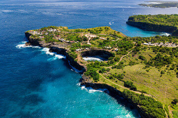 Scenic coastal landscape showing the natural rock arch of Broken Beach in Indonesia.