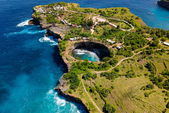 Dramatic coastal cliffs and collapsed sea cave of Pasih Uug, Nusa Penida