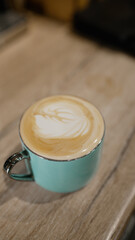 Latte art in a turquoise coffee mug