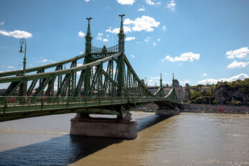 Budapest, Hungary - July 27, 2025: The Liberty Bridge spanning the Danube River, a historic green steel bridge connecting Buda and Pest, completed in 1896

