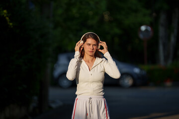 Happy young woman enjoying morning sunlight during outdoor exercise in nature	