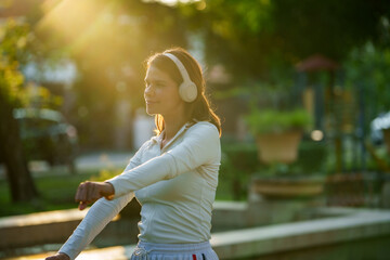 Wellness and balance concept with woman feeling relaxed and recharged under warm natural light.