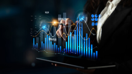A businesswoman uses a tablet to explore stock market data with dynamic graphs and charts, illustrating modern financial analysis techniques in a professional setting. Scalp
