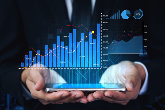 A businessman analyzes financial performance using a smartphone displaying digital graphs, emphasizing modern technology in business strategy and market analysis. Scalp