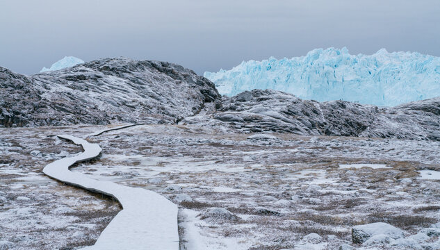 Giant icebergs floating in Ilulisat icefjord, Greenland. Massive icebergs, calved from the Sermeq Kujalleq Glacier, float through the Ilulissat Icefjord in western Greenland