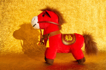 Chinese New Year of Horse mascot on golden background the Chinese word means fortune