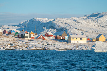 Traditional greenlandic colorful wooden houses in the Oqaatsut village, Ilulissat, Greenland, on a sunny, cold day of late autumn © Petr